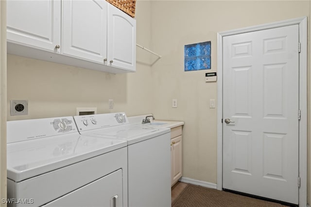 clothes washing area featuring washer and dryer, cabinets, and sink