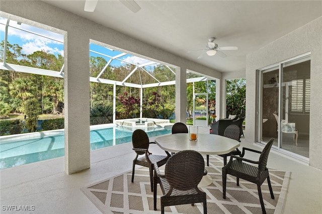 sunroom featuring ceiling fan and a pool