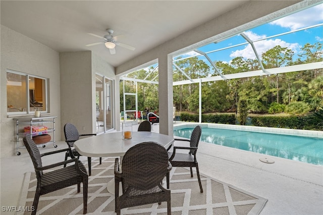 exterior space with a patio, glass enclosure, and ceiling fan