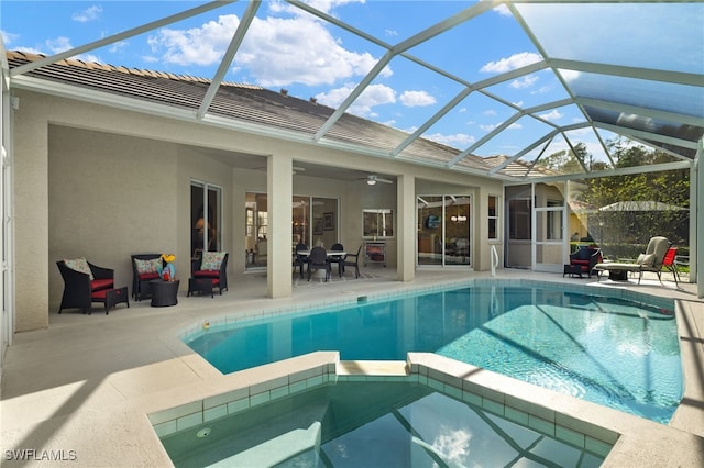 view of swimming pool with a lanai, an in ground hot tub, ceiling fan, and a patio