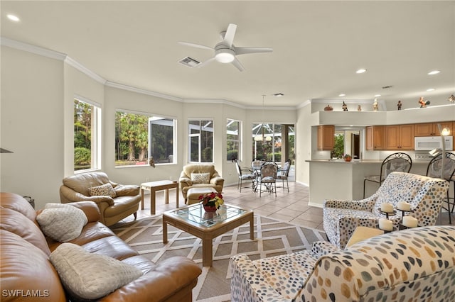 tiled living room featuring ceiling fan and crown molding