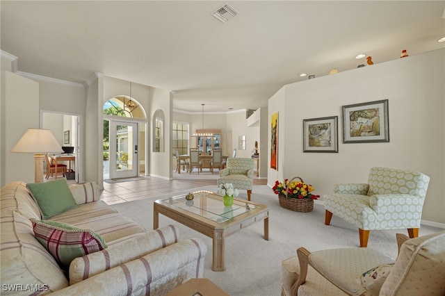 tiled living room with crown molding and a notable chandelier