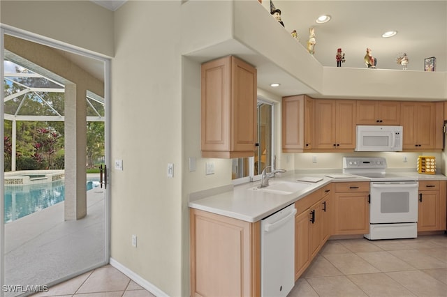 kitchen featuring light brown cabinets, white appliances, sink, and light tile patterned floors