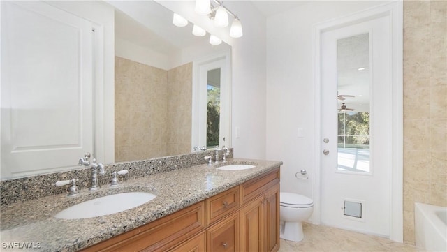 bathroom featuring tile patterned flooring, vanity, toilet, and a wealth of natural light