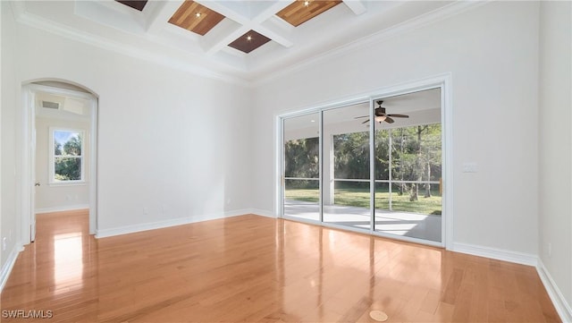 spare room featuring ceiling fan, coffered ceiling, beamed ceiling, light wood-type flooring, and ornamental molding