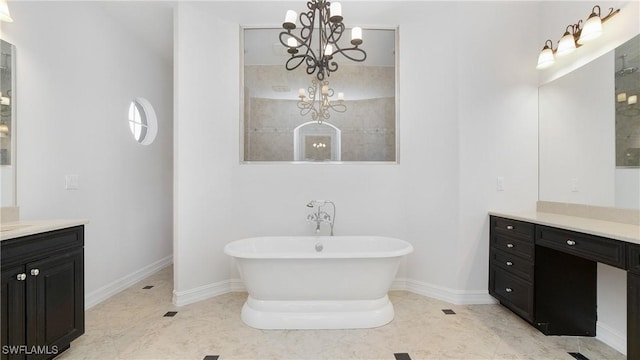 bathroom featuring a bathing tub, tile patterned flooring, vanity, and a chandelier