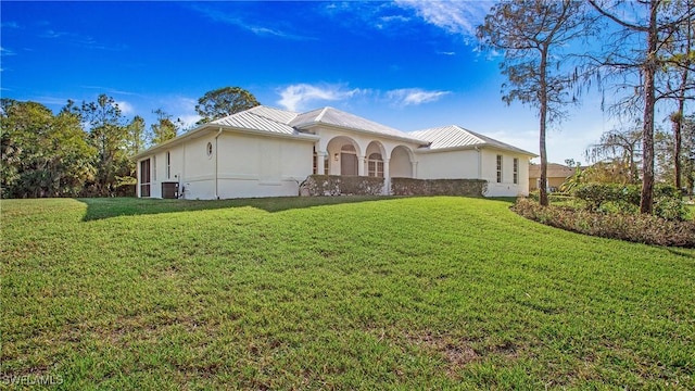 view of front of property featuring central AC and a front lawn