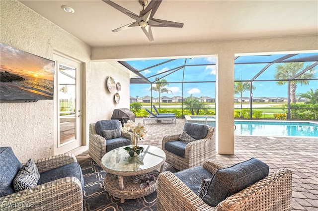 view of patio with outdoor lounge area, glass enclosure, and grilling area