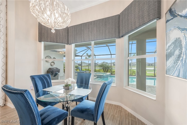 dining area featuring a chandelier, hardwood / wood-style flooring, and crown molding