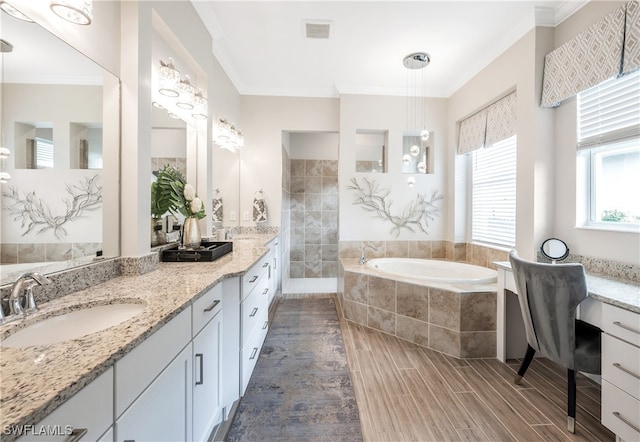 bathroom featuring ornamental molding, vanity, and independent shower and bath