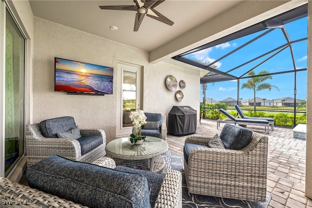 view of patio / terrace featuring an outdoor living space, area for grilling, a lanai, and ceiling fan