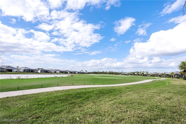 surrounding community featuring a yard and a water view