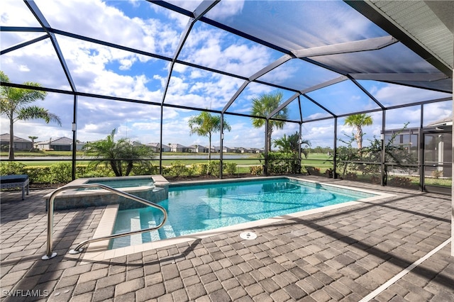 view of pool featuring a lanai, an in ground hot tub, and a patio