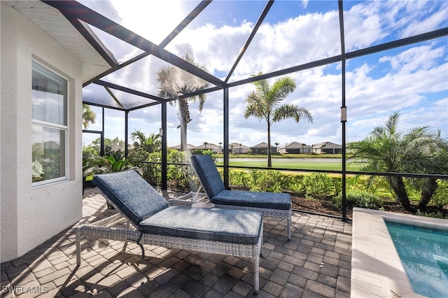 view of patio / terrace featuring glass enclosure