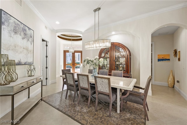 dining room featuring french doors, light tile patterned flooring, ornamental molding, and an inviting chandelier