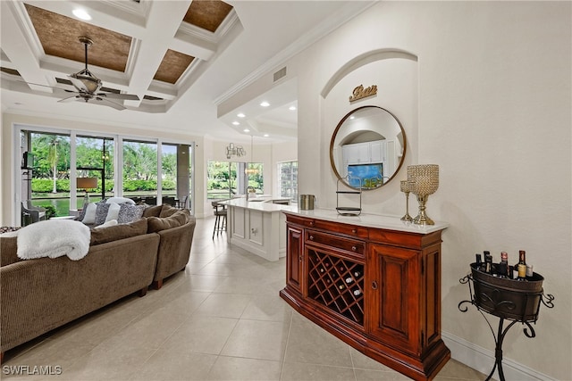 bar featuring ceiling fan, beam ceiling, crown molding, and coffered ceiling