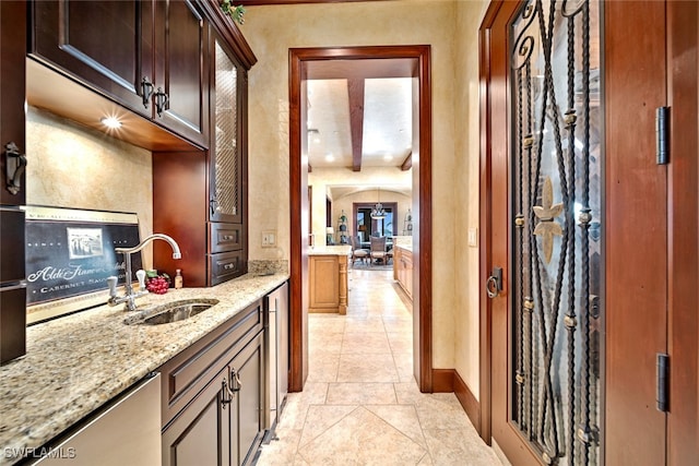 interior space with light stone counters and sink