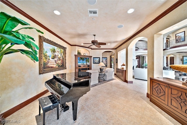 interior space with ceiling fan and ornamental molding