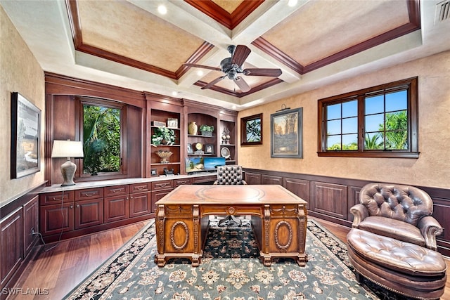 office space featuring beam ceiling, ceiling fan, coffered ceiling, dark hardwood / wood-style flooring, and ornamental molding