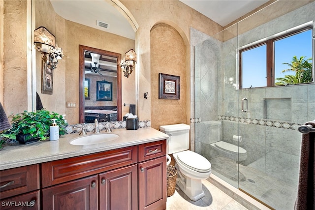 bathroom with tile patterned flooring, vanity, toilet, and a shower with door