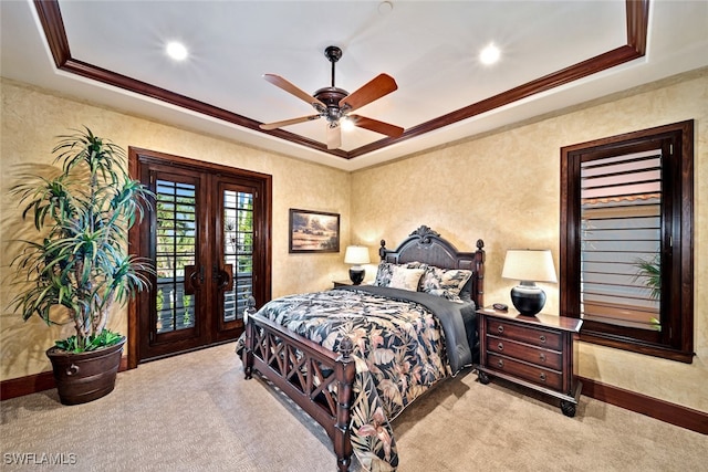 carpeted bedroom featuring access to outside, ceiling fan, a tray ceiling, and ornamental molding