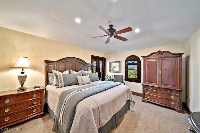 bedroom featuring ceiling fan, light colored carpet, and lofted ceiling