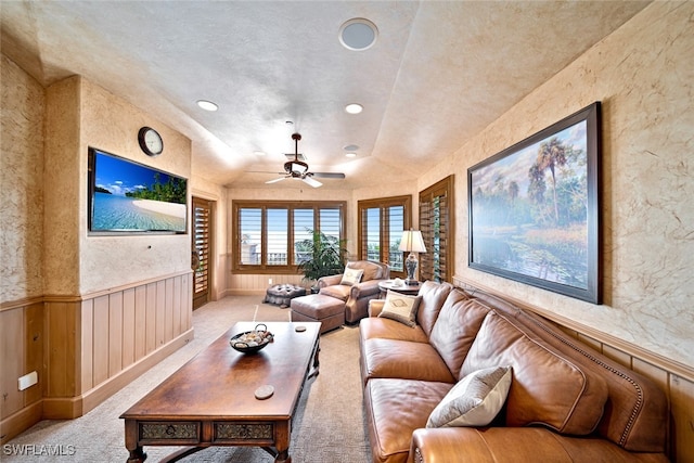 carpeted living room with ceiling fan