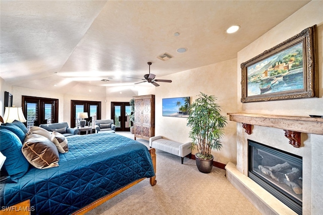 bedroom featuring carpet flooring, french doors, and a premium fireplace