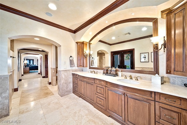 bathroom with vanity and ornamental molding