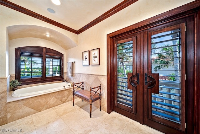 entrance foyer featuring a healthy amount of sunlight, ornamental molding, and french doors