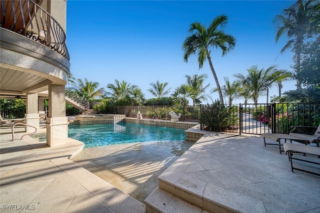 view of pool featuring a patio area and an in ground hot tub