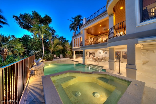 view of pool with an in ground hot tub and a patio