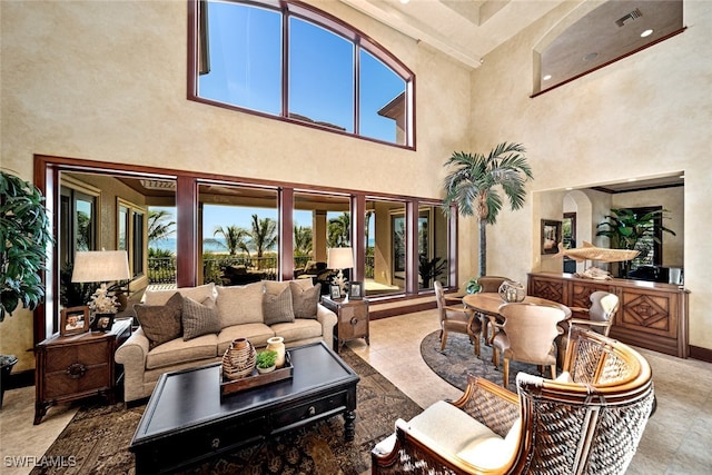 living room featuring a towering ceiling