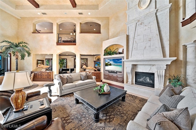 living room featuring a premium fireplace and a high ceiling