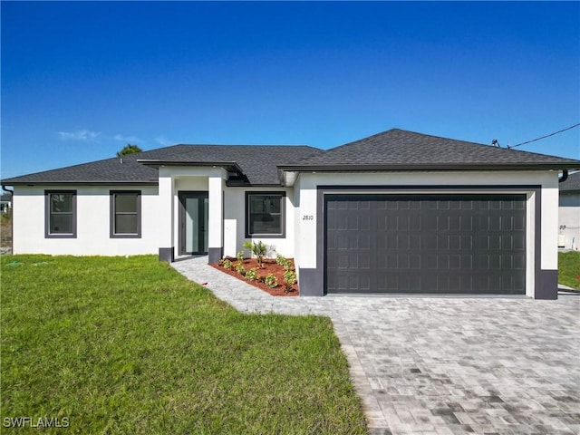 view of front facade with a front yard and a garage