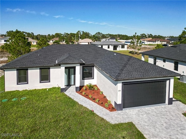 view of front of property with a front yard and a garage