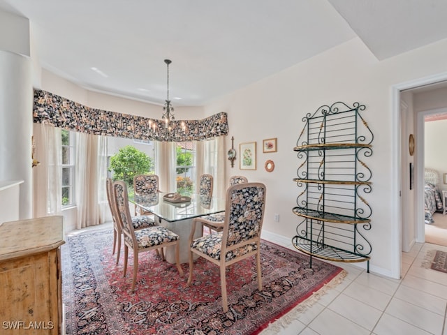 dining space with a wealth of natural light, light tile patterned floors, and a chandelier