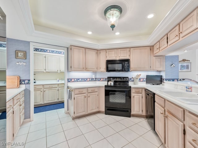 kitchen featuring a raised ceiling, light brown cabinetry, black appliances, and sink