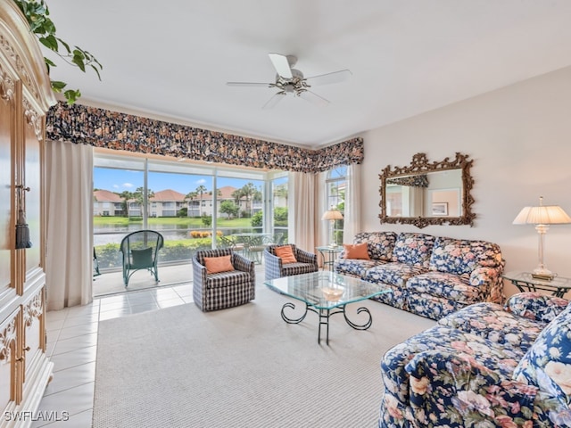 tiled living room featuring ceiling fan and a healthy amount of sunlight