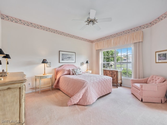 bedroom with ceiling fan and light carpet