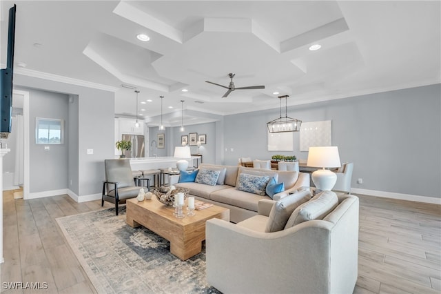 living room featuring ceiling fan, sink, light hardwood / wood-style floors, and ornamental molding