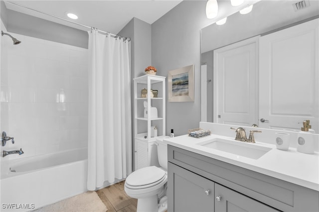 full bathroom with wood-type flooring, vanity, toilet, and shower / bath combo with shower curtain