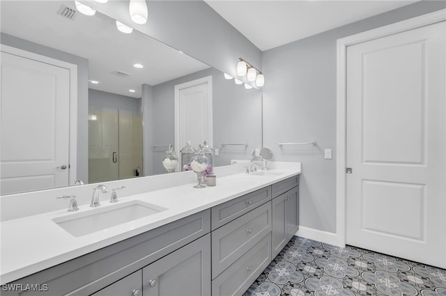 bathroom with tile patterned floors, vanity, and a shower with shower door