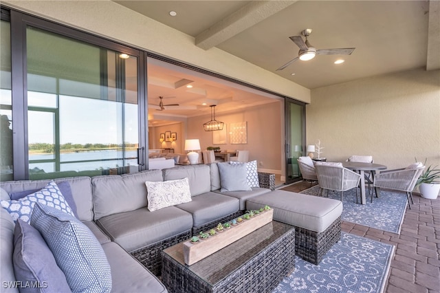 view of patio with outdoor lounge area, a water view, and ceiling fan