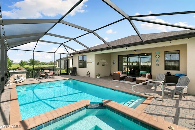 view of pool with an outdoor living space, a patio area, ceiling fan, and a lanai