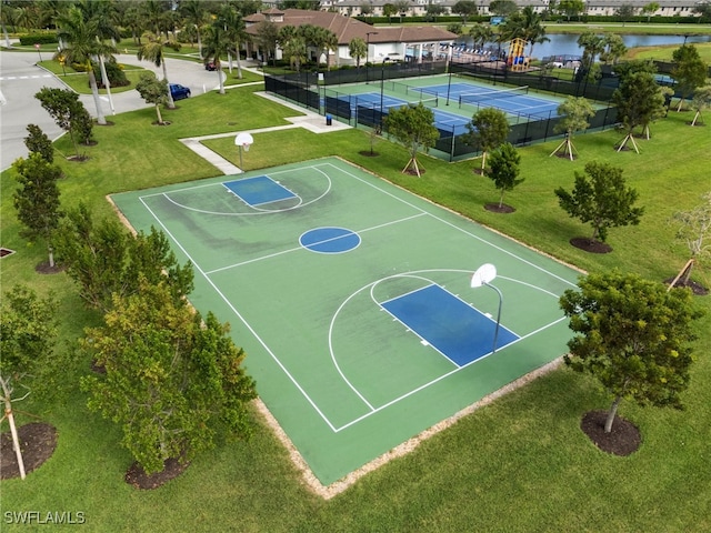 view of basketball court featuring tennis court and a water view