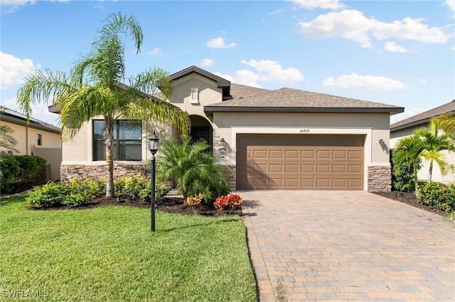 view of front of property featuring a garage and a front lawn