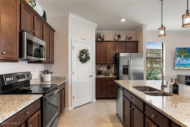 kitchen with decorative light fixtures, sink, ornamental molding, and stainless steel appliances