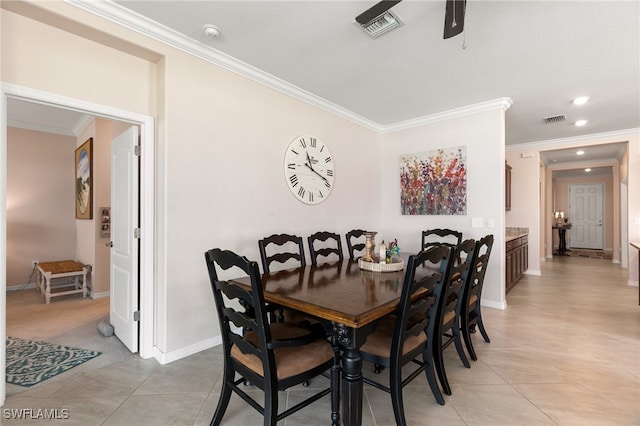 dining room featuring ceiling fan, ornamental molding, and light tile patterned flooring