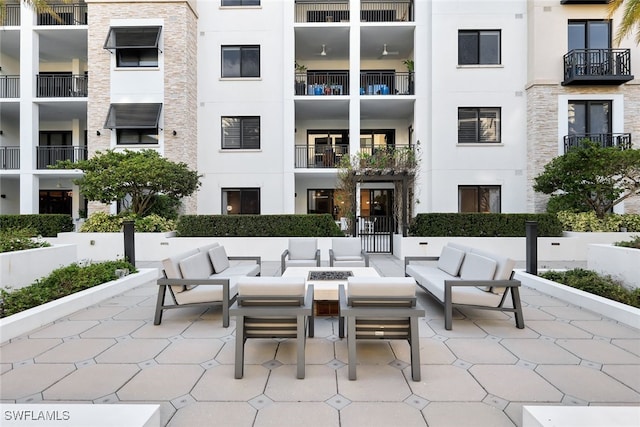 exterior space featuring an outdoor living space with a fire pit